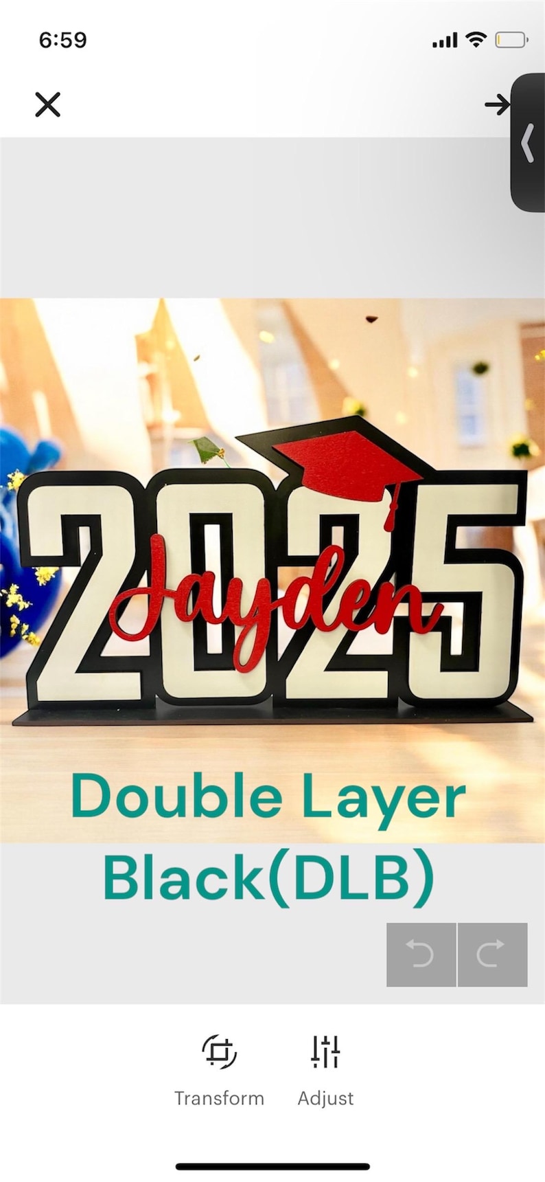 May include: A black and white layered wooden sign with the year "2025" and the name "Jayden" in red. The sign has a graduation cap on top and is on a wooden surface. The text "Double Layer Black (DLB)" is below the sign.