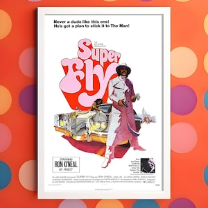 May include: A framed vintage movie poster for "Super Fly" starring Ron O'Neal. The poster has a retro design with the title in pink and orange, and an image of a man in a white and pink suit. The poster includes text at the top and bottom.