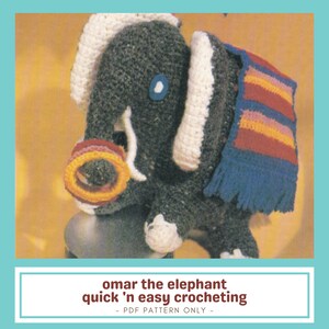 May include: A handmade crochet elephant in grey, white, and blue, wearing a striped scarf and a ring around its trunk. The image includes the text "omar the elephant quick 'n easy crocheting" below the elephant.
