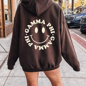 Gamma Phi Beta Smiley Sorority Sweatshirt | Trendy GPhi Custom Sorority Hoodie | Available in Brown Black Green Blue & Pink