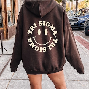Sigma Sigma Sigma Smiley Sorority Sweatshirt | Trendy Tri Sigma Custom Sorority Hoodie | Available in Brown Black Green Blue & Pink