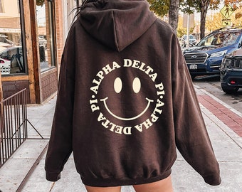 Alpha Delta Pi Smiley Sorority Sweatshirt | Trendy ADPi Custom Sorority Hoodie | Available in Brown, Black, Green, Blue & Pink