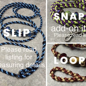 May include: Three different types of dog leashes: a slip leash with blue and black cord, a snap leash with green and purple cord, and a loop leash with brown and gold cord. Each leash has a different type of clasp and decorative beads.