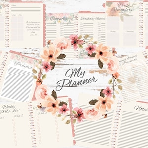 May include: A floral-themed planner with pages for goals, prayers, weekly to-do lists, contacts, birthday reminders, daily reminders, online accounts and passwords, and notes. The planner has a pink and white color scheme with a floral wreath design.