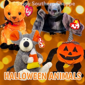 May include: A collection of plush Halloween animals, including an orange cat, a gray bat, a gray mouse holding candy corn, and a jack-o'-lantern. Each animal has a Ty heart tag. The text "HALLOWEEN ANIMALS" is at the bottom.
