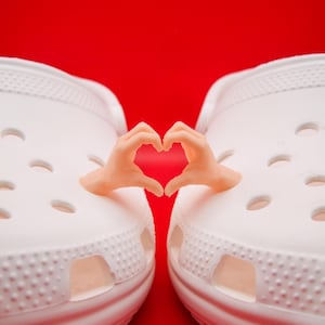 May include: A white ceramic mug with a black handle and the text "But First, Coffee" in a black, bold font. The mug is sitting on a white surface. The mug is approximately 4 inches tall.