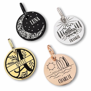 May include: Four round pet ID tags with different designs. One is black with a moon and stars and the name "LUNA". Another is white with a camper van and the name "FRANKIE". A gold tag has the name "APOLLO". A rose gold tag has surfboards and the name "CHARLIE".