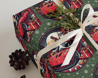 May include: Gift wrap featuring a repeating pattern of red sports cars, Santa Claus, and wrapped gifts on a dark green background with snowflakes. A white ribbon and pine sprig adorn the wrapped gift.