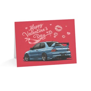May include: A Valentine's Day card featuring a blue Mitsubishi Lancer Evolution with pink hearts and lips in the background. The card reads "Happy Valentine's Day".