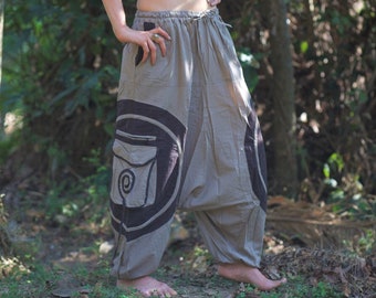 May include: Gray cotton pants with a black and white design. The pants have a drawstring waist and a large pocket on the left leg.