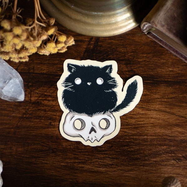 Sticker 'Witchy Cats - Skull Cat' with a motif of a black witchy cat sitting on a skull - high-quality matt vinyl sticker