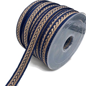 May include: A spool of navy blue and gold trim with a chevron pattern. The trim is approximately 1/2 inch wide.