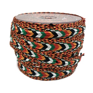 May include: A spool of braided trim with a chevron pattern in orange, red, green, black, and white.