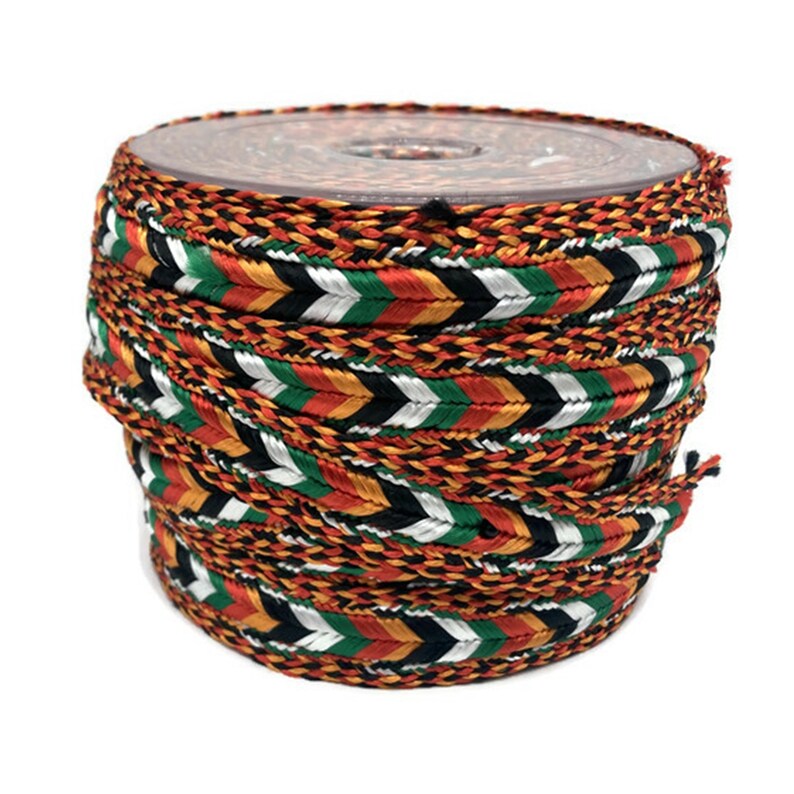 May include: A spool of braided trim with a chevron pattern in orange, red, green, black, and white.