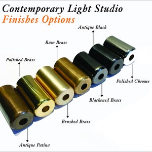 May include: A row of seven metal lamp finials in different finishes, including antique patina, brushed brass, polished brass, raw brass, blackened brass, antique black, and polished chrome.