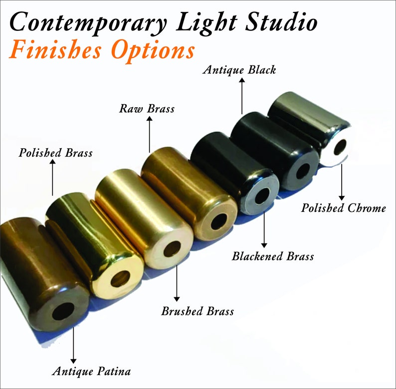 May include: A row of seven metal lamp finials in different finishes, including antique patina, brushed brass, polished brass, raw brass, blackened brass, antique black, and polished chrome.