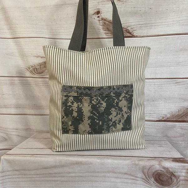 White and tan striped tote embellished with repurposed army uniforms and cotton lined with vintage lace napkin pockets