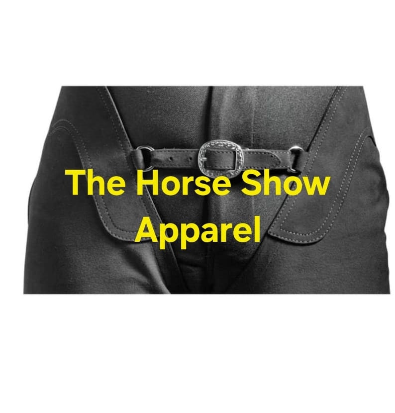 May include: Black riding breeches with a leather belt and silver buckle. The text "The Horse Show Apparel" is printed in yellow on the front of the breeches.