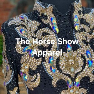 May include: Black show shirt with gold and iridescent embellishments. The shirt features a floral design and the text "The Horse Show Apparel".