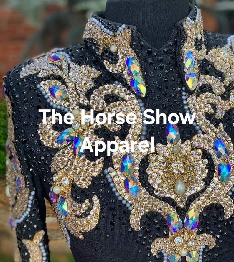 May include: Black show shirt with gold and iridescent embellishments. The shirt features a floral design and the text "The Horse Show Apparel".