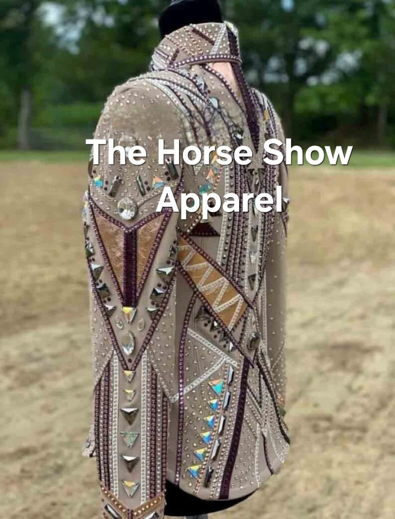 May include: A beige show jacket with intricate geometric designs and rhinestones. The jacket features a high collar and long sleeves. The text "The Horse Show Apparel" is visible on the jacket.