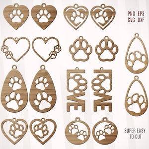 Puede incluir: Un conjunto de 12 diseños de pendientes de madera cortados con láser con huellas de patas. Los diseños incluyen corazones, huellas de patas y la palabra "LOVE".