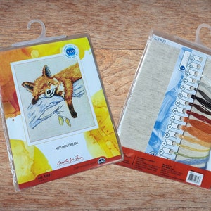 May include: A cross-stitch kit featuring a sleeping fox on a branch with autumn leaves. The kit includes a piece of Aida cloth, floss, and instructions. The packaging is labelled "Autumn Dream" and "Create for Fun".