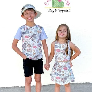 May include: A short-sleeve t-shirt with a light blue and white western-themed print, black shorts, and black high-top sneakers, alongside a sleeveless top and matching skirt with the same western print and black sneakers.