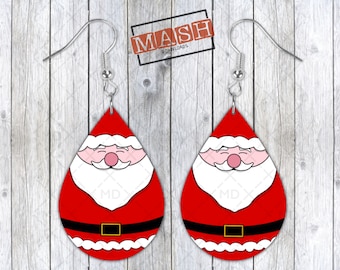 May include: A pair of teardrop-shaped Christmas earrings featuring Santa Claus. The earrings have a red background with a white beard, pink nose, and black belt with a gold buckle. The earrings hang from silver-colored hooks.