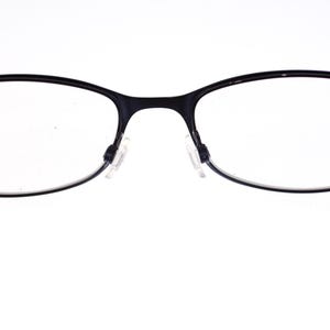 May include: Black-framed spectacles with oval lenses. The glasses have a thin frame and nose pads. The temples are dark and extend to the sides. The background is white.