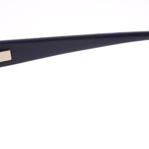 May include: A close-up of black eyeglasses. The frames have a silver rectangular detail on the temple. The arm of the glasses has the text "Specsavers 4001722 CE". The lenses are clear.