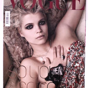 May include: Vogue magazine cover featuring a woman with short blonde hair and dark eye makeup. The cover text reads "So young, so cool" and "Pink  Gingham".