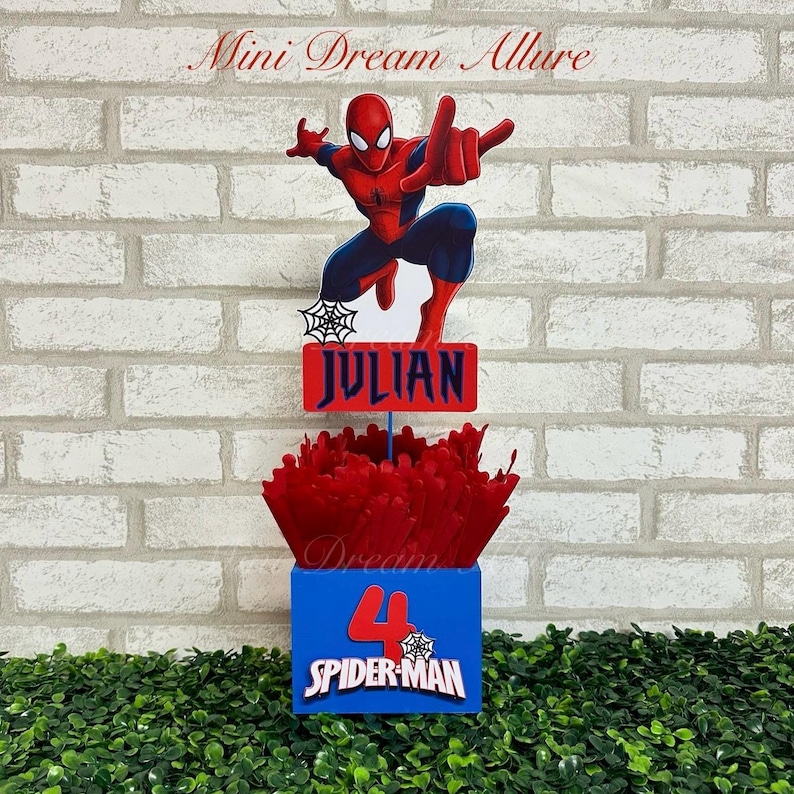 May include: A red and blue Spider-Man themed centerpiece with a red and blue box that says "Spider-Man" and the number "4". The centerpiece also has a red and blue sign that says "JULIAN" and a red and blue Spider-Man figure.