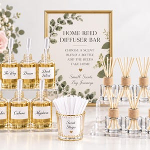 May include: A home reed diffuser bar set featuring a gold-framed sign with green leaf illustrations and text, seven glass bottles with droppers and labels, a gold-rimmed glass cup with white scent strips, and seven small glass reed diffusers.