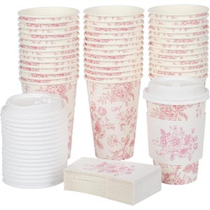 May include: A selection of disposable coffee cups, lids, and napkins. The cups and napkins display a floral design in red on a cream backdrop. The cups are stacked in multiple piles, with one cup assembled with a lid and a cup sleeve.