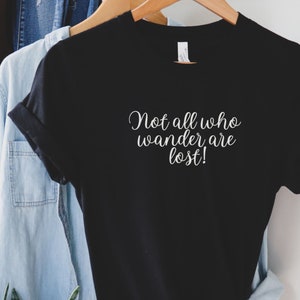 May include: Black t-shirt with white text that reads "Not all who wander are lost!"