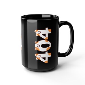 May include: Black ceramic mug with a large handle. The mug features the number "404" in white with orange cat faces. The mug is a standard size for coffee or tea.