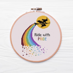 May include: A cross-stitch embroidery hoop with a rainbow, a witch flying on a broomstick, and the text "Ride with PRIDE".