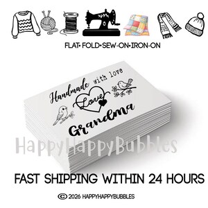 May include: A stack of white rectangular organic cotton labels featuring black printed text that reads Handmade with love, Grandma, accompanied by two bird illustrations and a heart icon. The top label displays the custom design clearly.