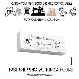 May include: A rectangular white fabric label featuring black text that reads handmade with love by Amy Austin, accompanied by a small bee graphic with a dotted flight path and a heart outline. The label is presented with icons of sewing items.