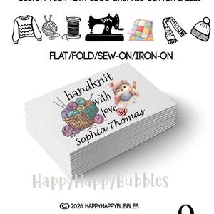 May include: A stack of white rectangular organic cotton labels featuring the text handknit with love by Sophia Thomas and an illustration of a bird in a hat next to a basket of yarn. The top text reads CUSTOM YOUR TEXT/ LOGO ORGANIC COTTON LABELS.