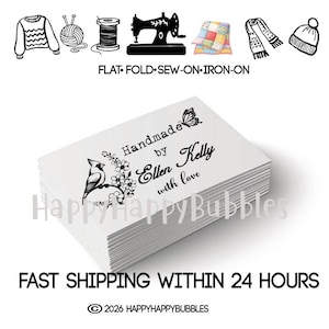 May include: A stack of white rectangular organic cotton labels featuring black printed text that reads Handmade by Ellen Kelly with love, accompanied by a graphic of a bird on a branch with flowers and a butterfly icon above the text.