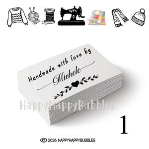 May include: A stack of white rectangular organic cotton labels featuring the black printed text Handmade with love by Michele and a heart icon. Above the labels are black icons of a sweater, yarn, thread, sewing machine, quilt, scarf, and hat.