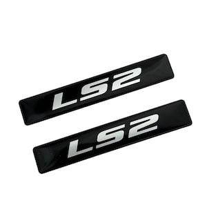 May include: Two black rectangular stickers with the text "LS2" in silver lettering.