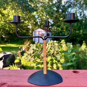 May include: A set of three ceramic mugs with a speckled, matte finish. The mugs are in shades of cream, light gray, and dark gray. Each mug has a simple, minimalist design and a rounded handle.