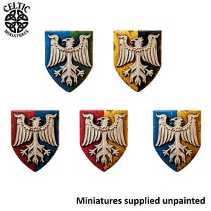 Puede incluir: Cinco emblemas en miniatura con forma de escudo que presentan un diseño de águila plateada en relieve. Cada escudo tiene un fondo de dos colores con texturas desgastadas. Las combinaciones incluyen azul y verde, amarillo y negro, rojo y azul, rojo y amarillo, y azul y amarillo. El texto dice Celtic Miniatures y Miniatures supplied unpainted.