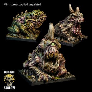 May include: Three painted fantasy monster miniatures on square bases. The creatures feature toad-like bodies with textured skin, sharp teeth, and horns. One has a single eye, while others have multiple eyes and open mouths. Text reads: Miniatures supplied unpainted.