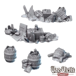 May include: A collection of unpainted grey resin miniature terrain pieces including piles of wooden debris, crates, barrels, and sacks. The set features various scattered wreckage items and individual barrel accessories with the text Vae Victis Miniatures.