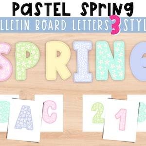 May include: Pastel spring bulletin board letters in three styles. The letters are in pink, light blue, and yellow with white flower patterns. The letters are on a light wood background.