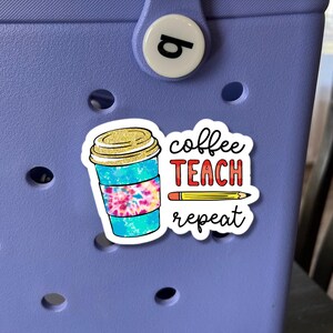 May include: A sticker featuring a coffee cup, a pencil, and the text "coffee teach repeat" in red, yellow, and blue.